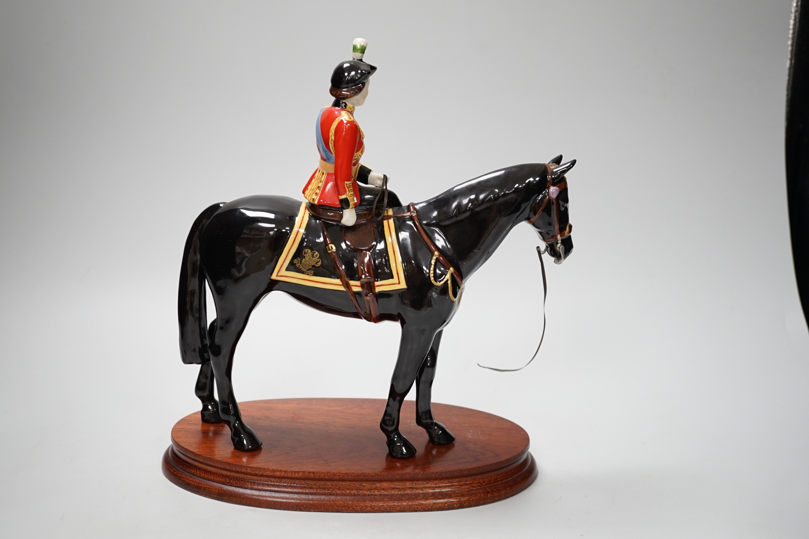 A Beswick ‘trooping the colour’ limited edition figure of Her Majesty The Queen on Burmese, on stand. 151/500